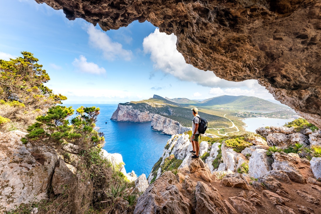 Hiker admiring the view from Capo Caccia.