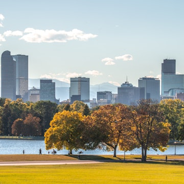 A park and city skyline in Denver.