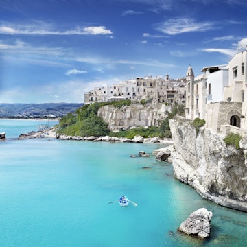 Medieval town of Vieste perched on cliff ridge.