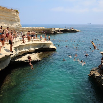Marsaxlokk, Malta – August 13, 2019: St. Peter's Pool near Marsaxlokk. A very popular place for Locals and Tourists. Malta