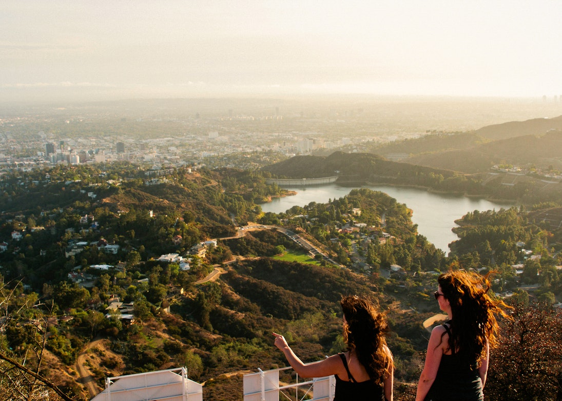 Two woman looking out over the Los Angeles skyline.