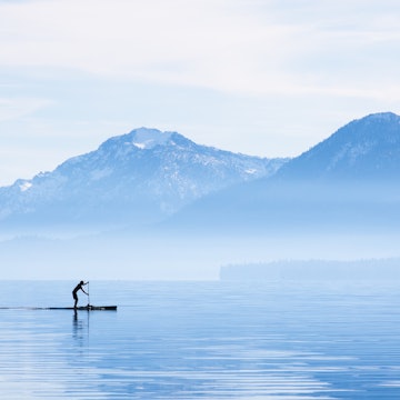 A paddleboarder goes for a morning cruise around the shore of Tahoe City. Lake Tahoe is a high alpine lake located in the Sierra Nevada Mountains, California.
1371032025