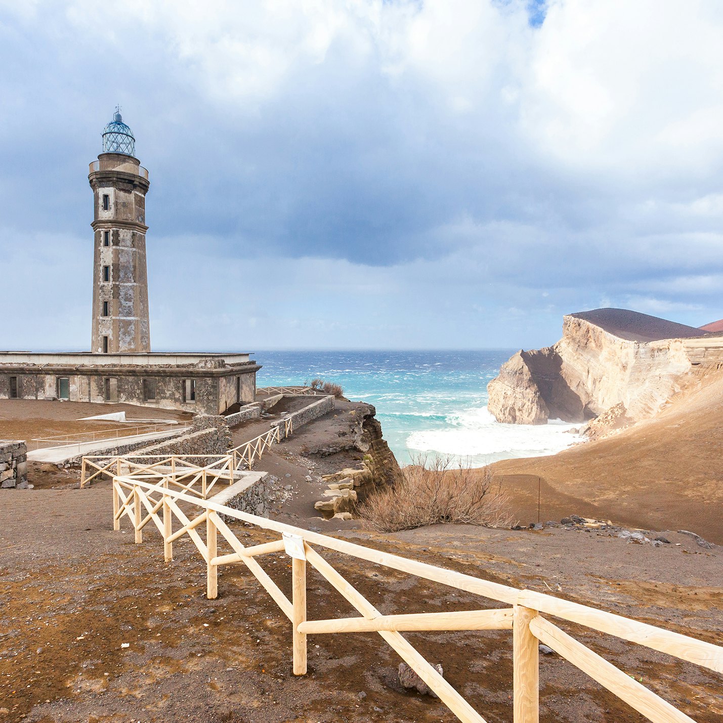 Lighthouse Capelinhos and dramatic landscape on the cliffs of island Faial, Azores islands; Shutterstock ID 169824179; Your name (First / Last): James Kay; GL account no.: 65050; Netsuite department name: Online Editorial; Full Product or Project name including edition: Azores destination page highlights