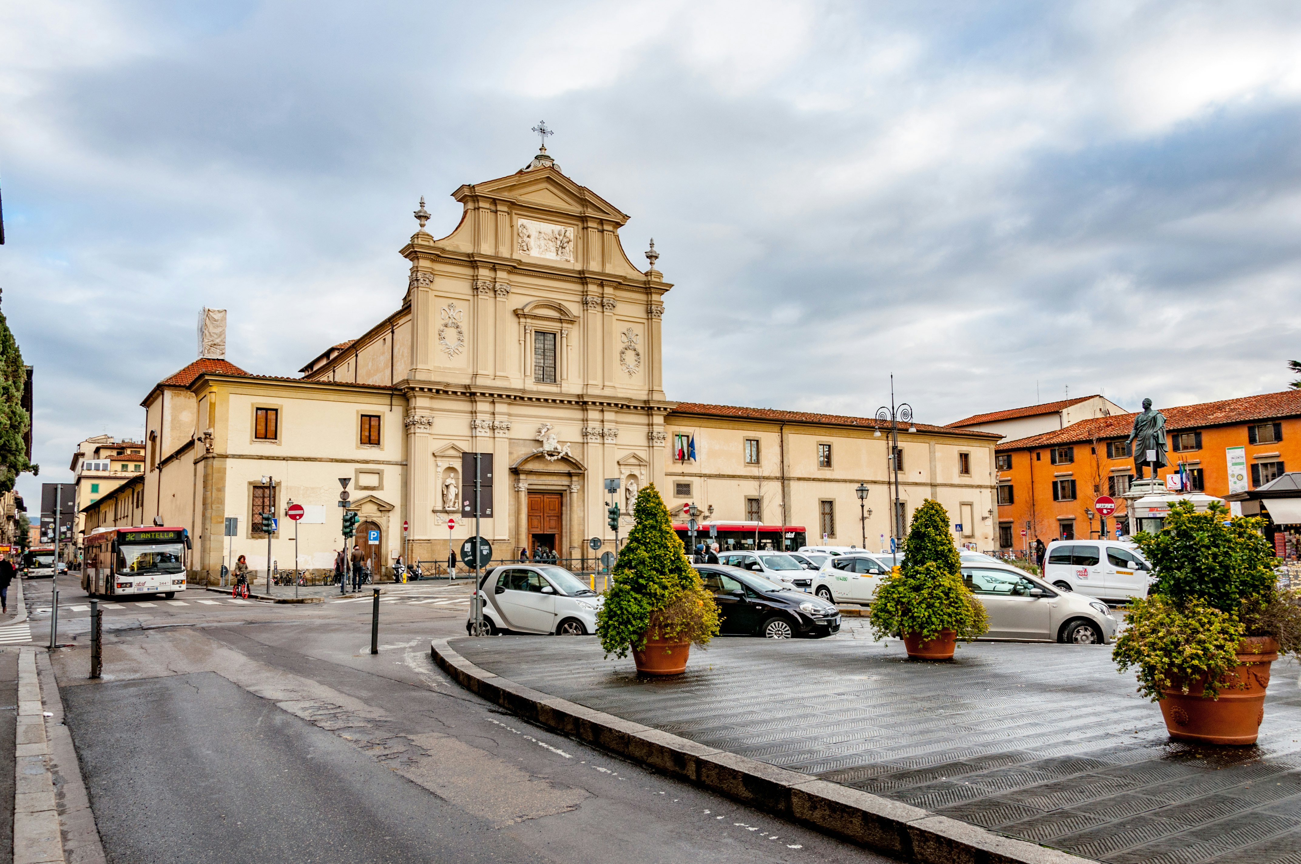 Cars in a tight parking area in front of a large building