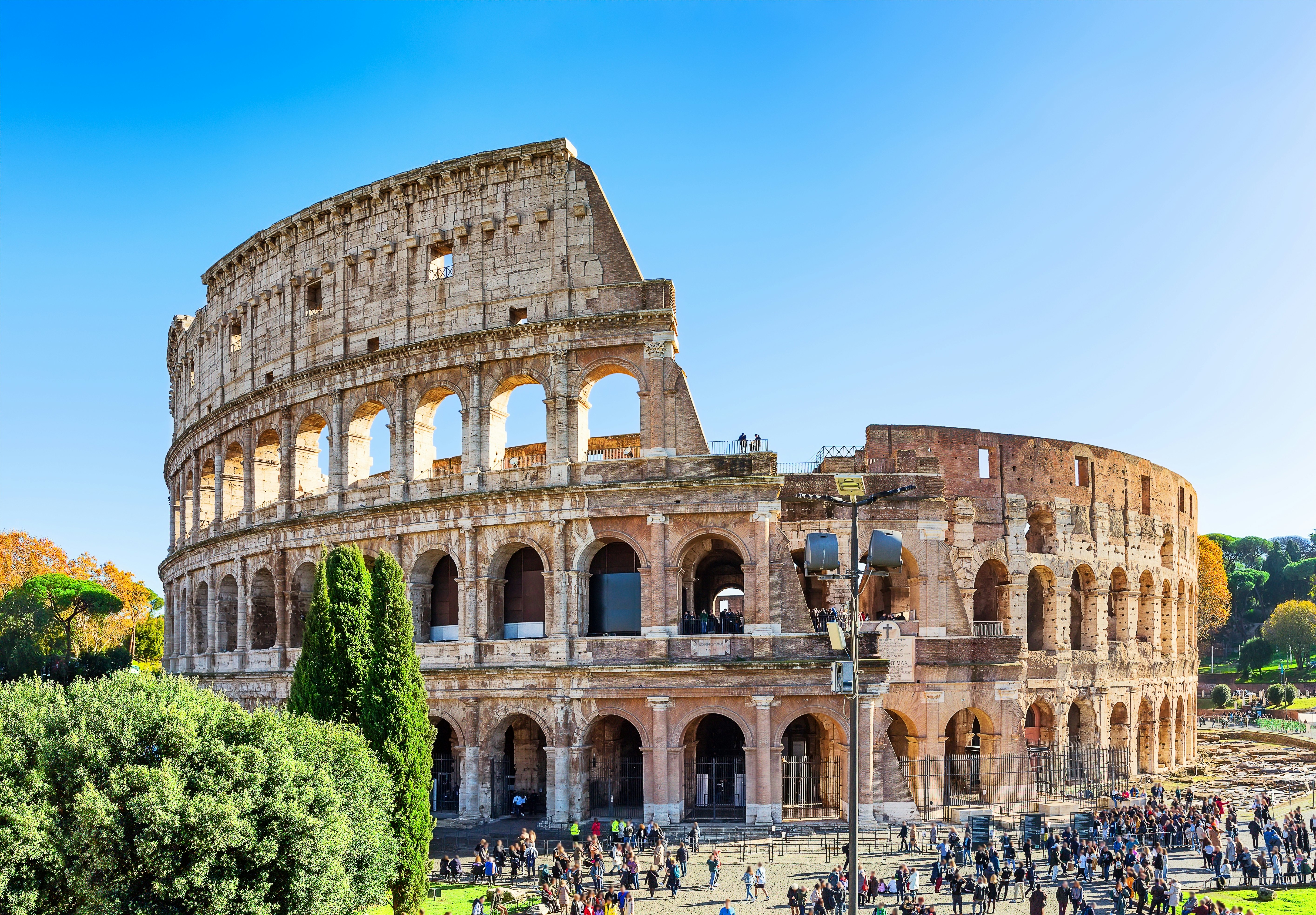 Colosseum (Coliseum) is one of main travel attraction of Rome, Italy. Ancient Roman ruins of Colosseum, landscape of old Rome city, Italy.