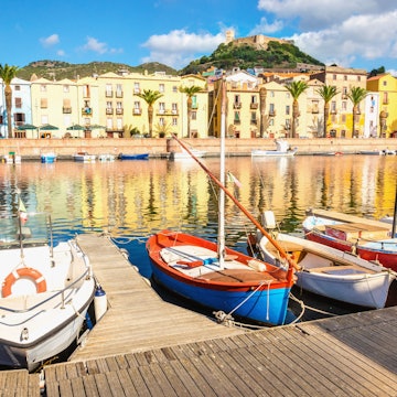 Colourful fishing boats moored on the river at Bosa.